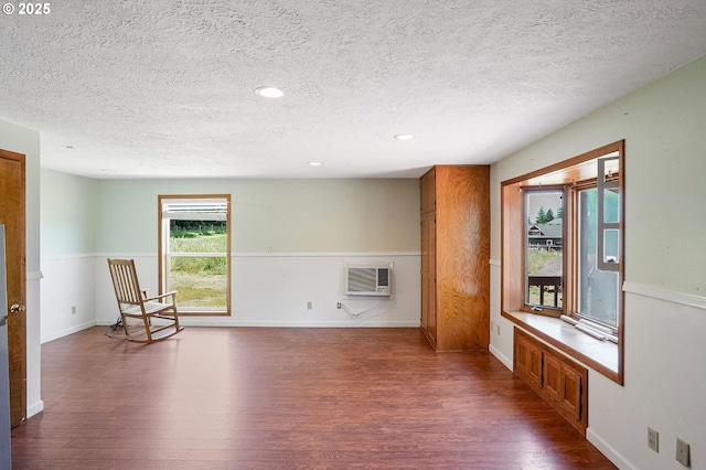 4269 Victor Point Rd, Silverton, OR 97381 - unfurnished room with dark wood finished floors, a textured ceiling, a wall mounted AC, and recessed lighting