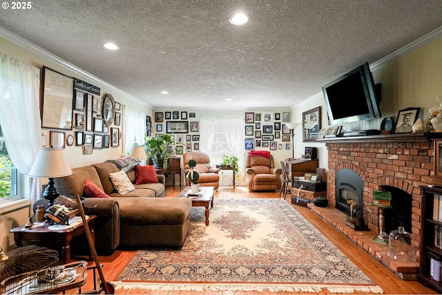 4269 Victor Point Rd, Silverton, OR 97381 - living area featuring hardwood / wood-style flooring, crown molding, a textured ceiling, a fireplace, and recessed lighting