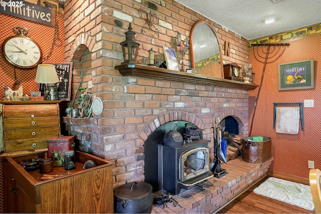 4269 Victor Point Rd, Silverton, OR 97381 - detailed view of a wood stove, a textured ceiling, and wood finished floors