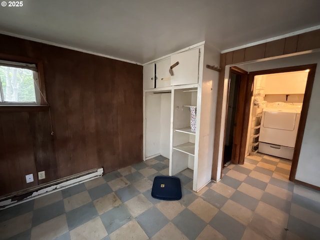 4576 Foulweather St, Florence, OR 97439 - unfurnished bedroom with tile patterned floors, a closet, wood walls, and washing machine and clothes dryer