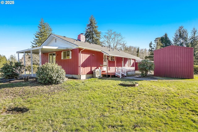 view of side of home with a yard