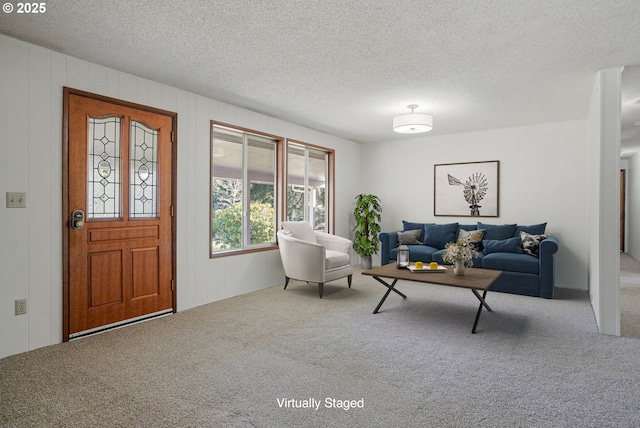 carpeted living room with a textured ceiling