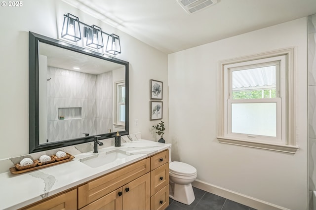 full bath featuring toilet, tile patterned flooring, vanity, and baseboards