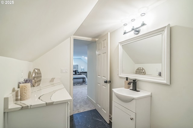 bathroom featuring vanity and lofted ceiling