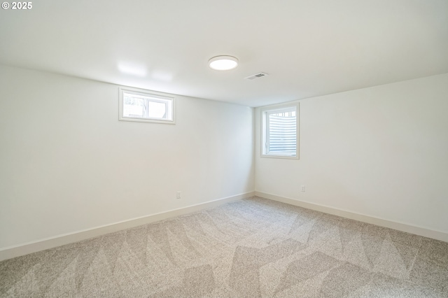 below grade area with carpet, plenty of natural light, and baseboards