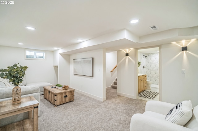 living area with recessed lighting, light carpet, baseboards, and stairway