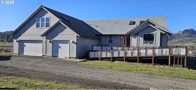 view of front of property with a garage and a wooden deck