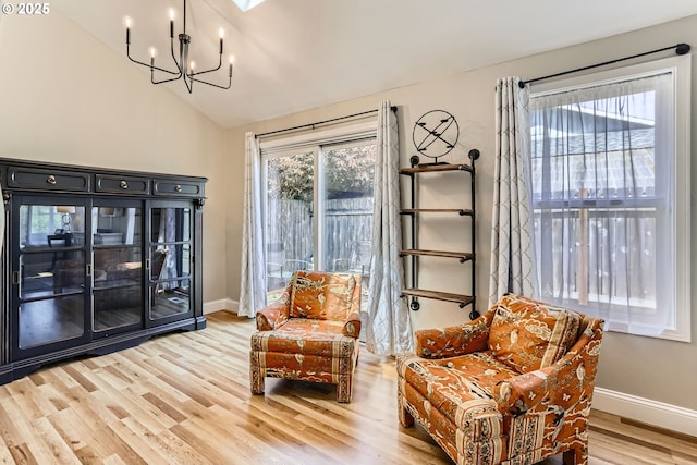 319 NE Hyde Cir, Hillsboro, OR 97124 - sitting room with lofted ceiling, a chandelier, light wood-style floors, and baseboards