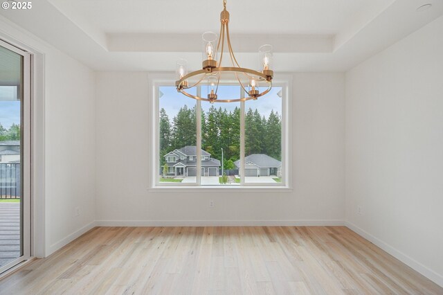310 W 20th Way, La Center, WA 98629 - spare room with a chandelier, a tray ceiling, wood finished floors, and baseboards