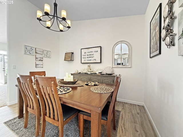 7205 Edge Cliff Dr, Brookings, OR 97415 - dining room featuring a chandelier, light wood-style flooring, and baseboards