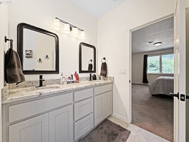7205 Edge Cliff Dr, Brookings, OR 97415 - ensuite bathroom featuring double vanity and baseboards