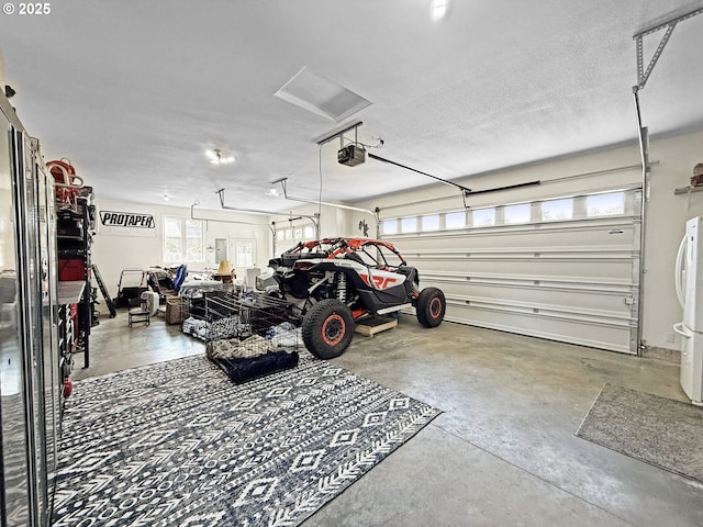 7205 Edge Cliff Dr, Brookings, OR 97415 - garage with a garage door opener and freestanding refrigerator