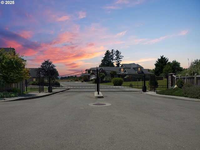 7205 Edge Cliff Dr, Brookings, OR 97415 - view of asphalt road with sidewalks, a gate, a gated entry, and curbs
