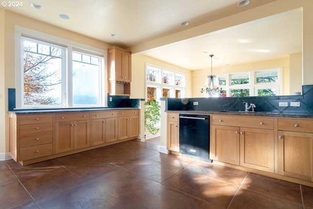 kitchen with tasteful backsplash, dishwasher, sink, and hanging light fixtures