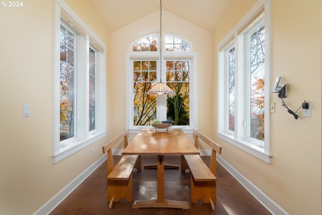 dining space featuring vaulted ceiling