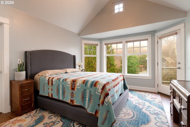 bedroom featuring lofted ceiling and access to outside