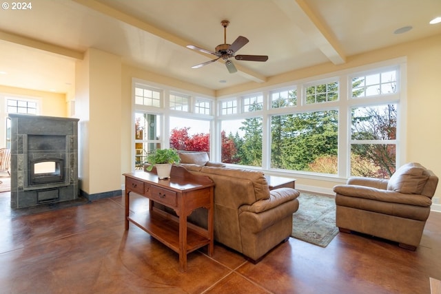 sunroom / solarium with beamed ceiling, ceiling fan, and a fireplace