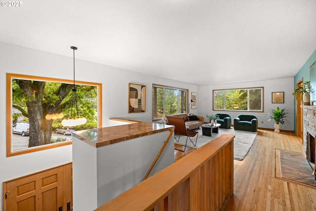 living room with light wood-type flooring and a fireplace with flush hearth