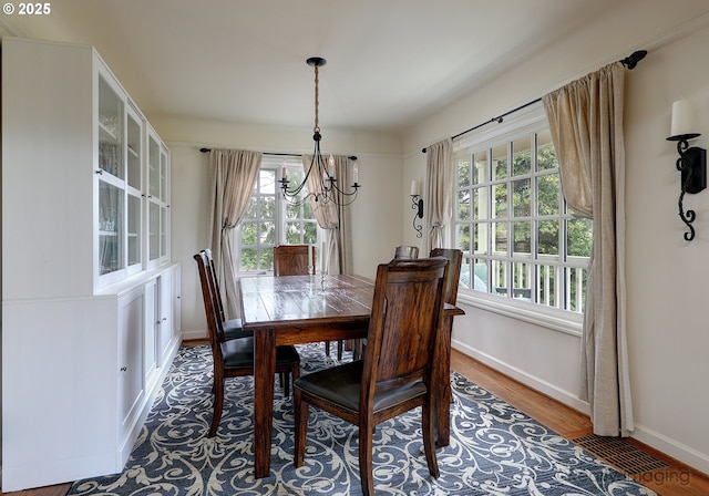 dining space featuring a chandelier and hardwood / wood-style floors