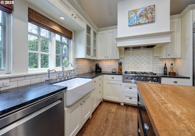 kitchen with dishwasher, wood counters, stainless steel gas cooktop, white cabinets, and tasteful backsplash