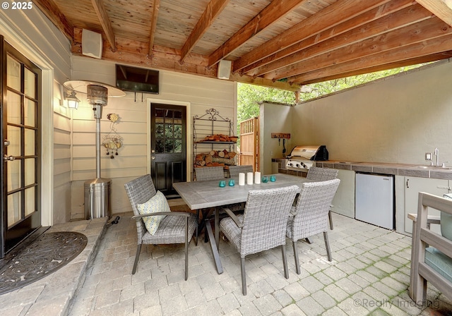 view of patio / terrace with grilling area and sink