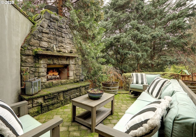 view of patio / terrace with an outdoor living space with a fireplace