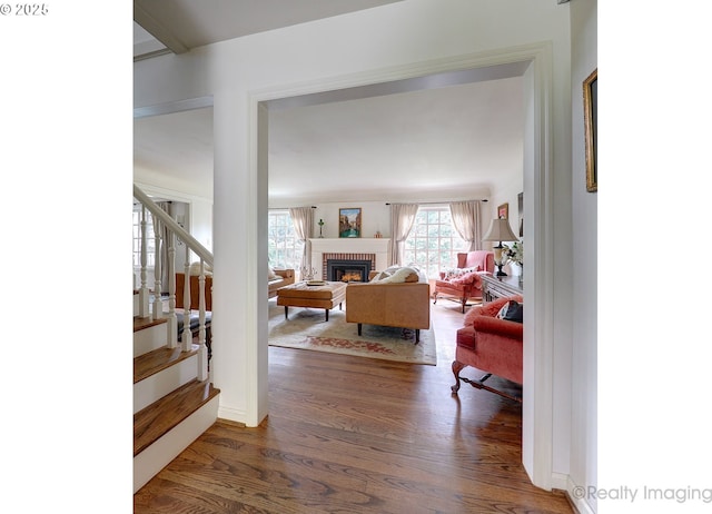 living room with dark hardwood / wood-style flooring and a fireplace