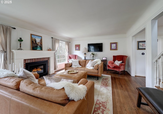 living room with a fireplace and dark hardwood / wood-style floors