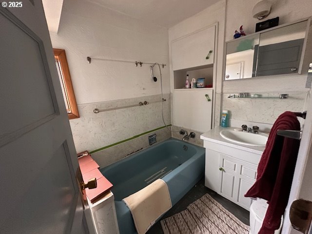 bathroom featuring a bath and vanity