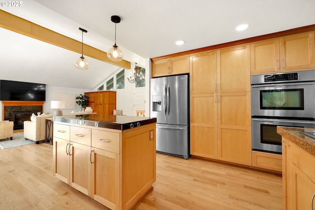 kitchen featuring a peninsula, light wood finished floors, appliances with stainless steel finishes, and recessed lighting