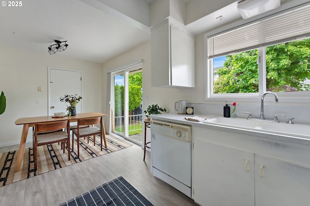 1520 SE 109th Ave, Portland, OR 97216 - kitchen with dishwasher, a sink, light countertops, and white cabinetry