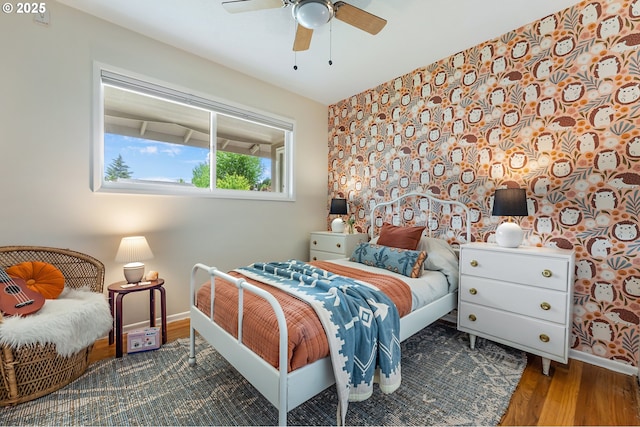 1520 SE 109th Ave, Portland, OR 97216 - bedroom with baseboards, wood finished floors, wallpapered walls, and ceiling fan