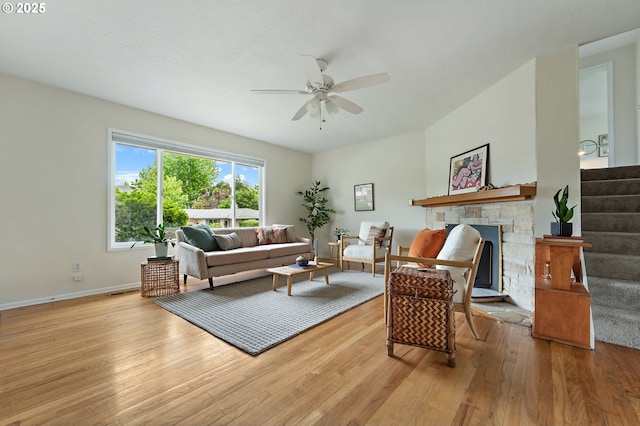 1520 SE 109th Ave, Portland, OR 97216 - living room featuring light wood-style floors, a ceiling fan, stairway, and a stone fireplace
