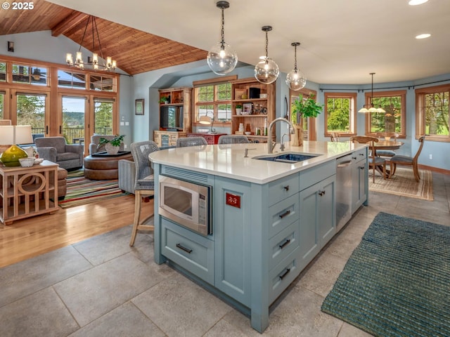 13615 NW Mason Hill Rd, North Plains, OR 97133 - kitchen with appliances with stainless steel finishes, a sink, open floor plan, light countertops, and a chandelier
