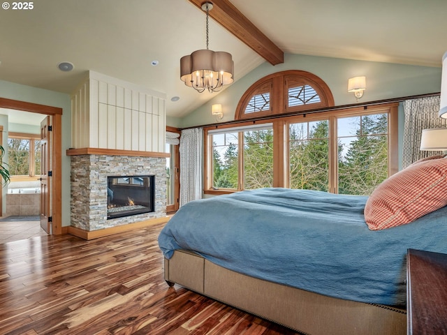 13615 NW Mason Hill Rd, North Plains, OR 97133 - bedroom featuring wood finished floors, a stone fireplace, a chandelier, and ensuite bath