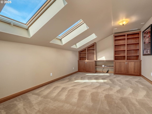 13615 NW Mason Hill Rd, North Plains, OR 97133 - additional living space with a skylight, carpet floors, vaulted ceiling, built in shelves, and baseboards