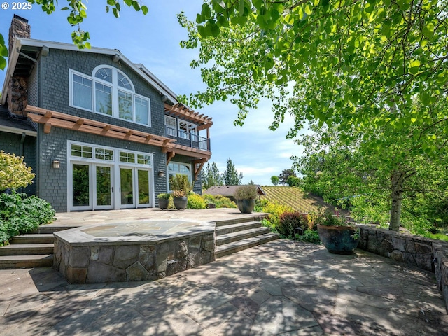 13615 NW Mason Hill Rd, North Plains, OR 97133 - back of property with a patio, a chimney, and french doors