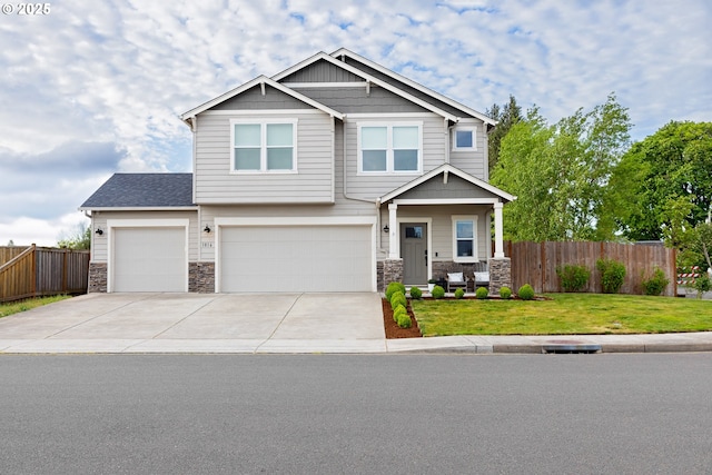craftsman house with stone siding, concrete driveway, and an attached garage