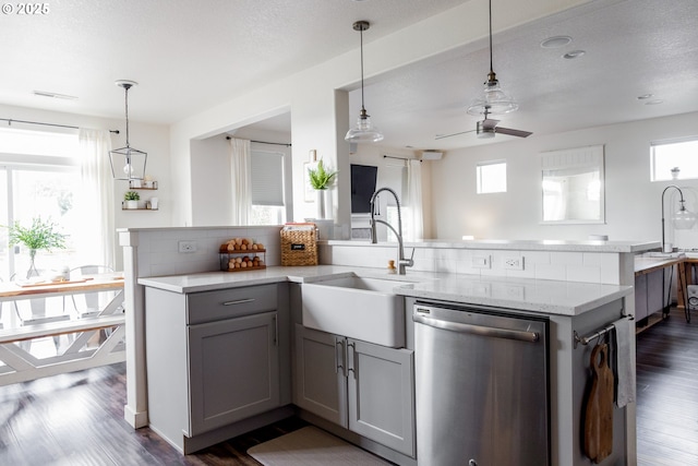 kitchen featuring stainless steel dishwasher, gray cabinets, healthy amount of natural light, and ceiling fan