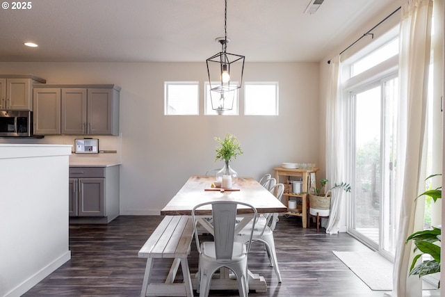 dining area with dark wood-style flooring, baseboards, and recessed lighting