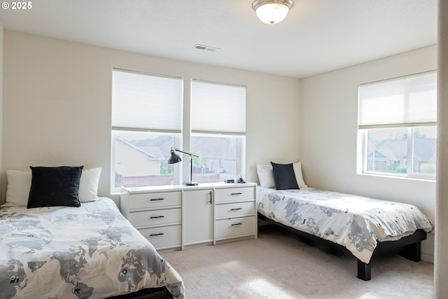 bedroom featuring light colored carpet