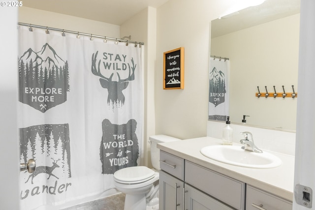 bathroom with vanity, toilet, curtained shower, and tile patterned flooring