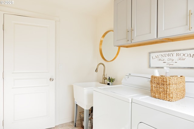 clothes washing area with cabinet space and independent washer and dryer