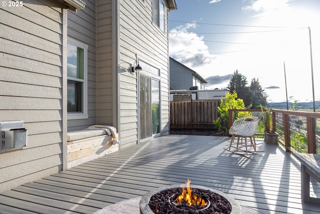wooden deck featuring an outdoor fire pit