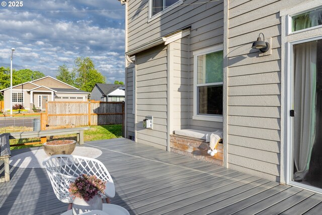 wooden terrace featuring fence