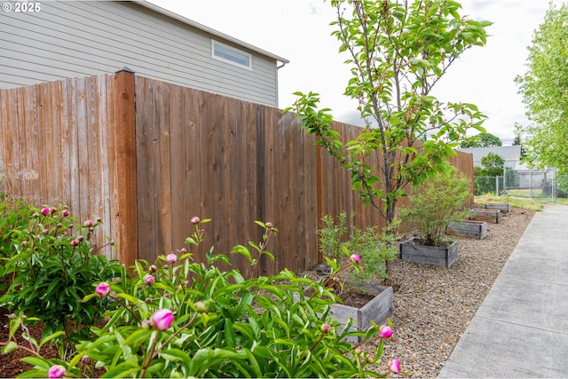 view of yard with a garden and fence
