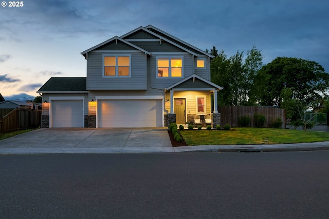 craftsman-style home featuring stone siding, concrete driveway, and an attached garage