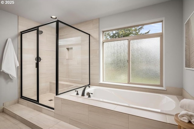 bathroom featuring independent shower and bath