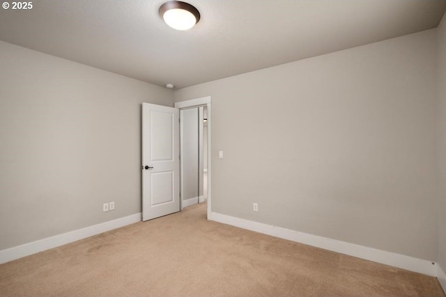 unfurnished room with light colored carpet