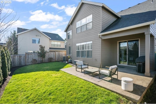 rear view of house with cooling unit, a yard, and a patio